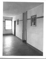SA0490 - Interior of a Shaker building, showing a window, wall pegs, and door. Identified on the back.